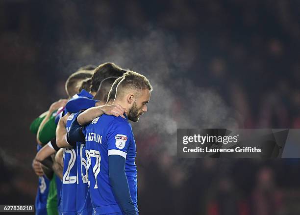 Oldham Athletic players observe a minutes silence for the victims of the plane crash involving the Brazilian club Chapecoense prior to the Emirates...