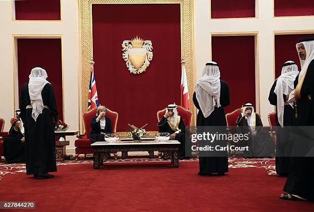 British Prime Minister Theresa May drinks tea with Khalifa bin Salman Al Khalifa, the Prime Minister of Bahrain, as she arrives at Sakhir Airbase on...