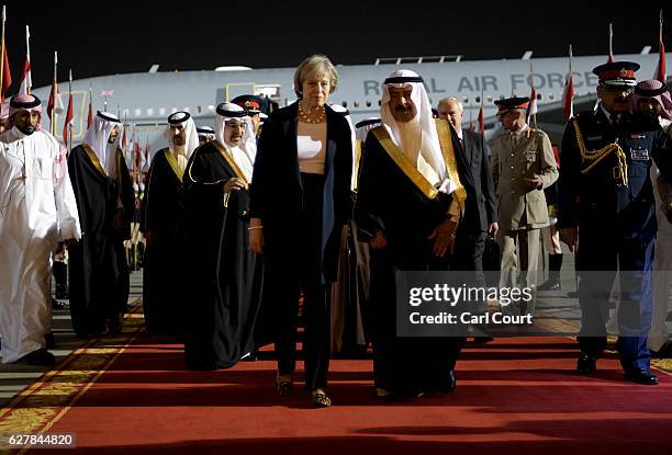 Khalifa bin Salman Al Khalifa, the Prime Minister of Bahrain, accompanies British Prime Minister Theresa May as she arrives at Sakhir Airbase on...