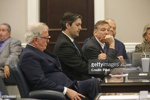 Defense attorneys Andy Savage, left, Don McCune, and Miller Shealy, right, sit around former North Charleston police officer Michael Slager at...