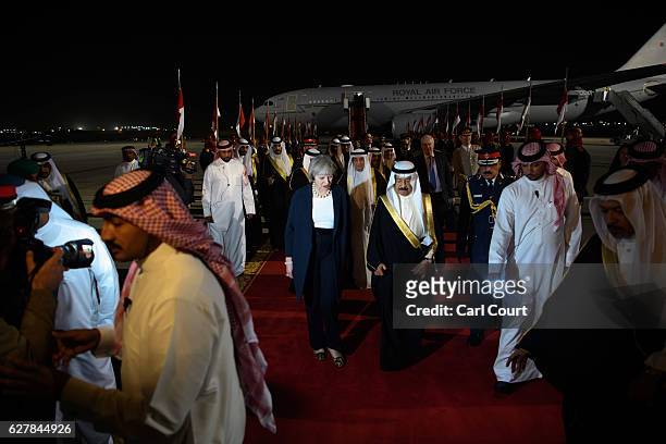 Khalifa bin Salman Al Khalifa, the Prime Minister of Bahrain , accompanies British Prime Minister Theresa May as she arrives at Sakhir Airbase on...