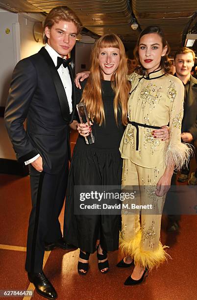 Jordan Barrett, Molly Goddard, winner of the British Emerging Talent award, and Alexa Chung pose backstage at The Fashion Awards 2016 at Royal Albert...