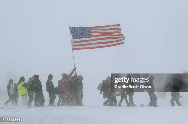 Despite blizzard conditions, military veterans march in support of the "water protectors" at Oceti Sakowin Camp on the edge of the Standing Rock...
