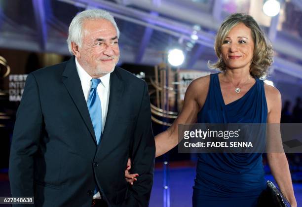 Former IMF chief Dominique Strauss-Kahn and his wife Myriam L'Aouffir pose on the red carpet at the Marrakech International Film Festival on December...
