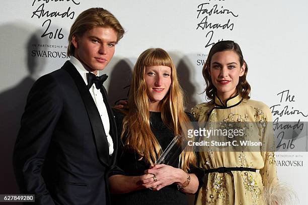 Designer Molly Goddard poses in the winners room with presenters Jordan Kale Barrett and Alexa Chung after winning the award for British Emerging...