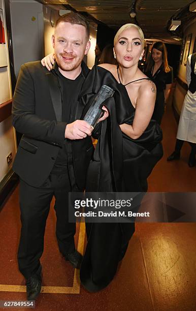 Craig Green, winner of the British Menswear Designer award, and Lady Gaga pose backstage at The Fashion Awards 2016 at Royal Albert Hall on December...