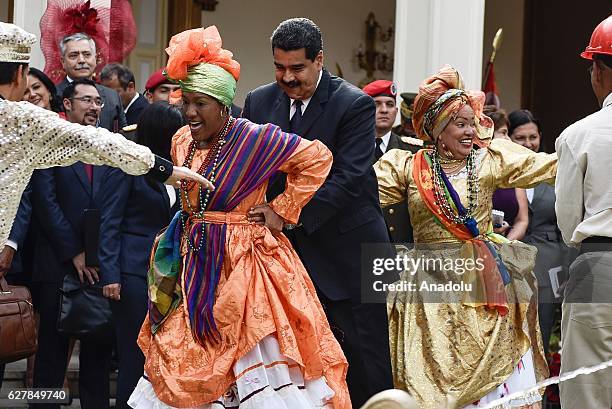 Venezuelan President Nicolas Maduro dances with a folkloric dance crew after a meeting with Trinidad and Tobago Prime Minister Keith Rowley at...