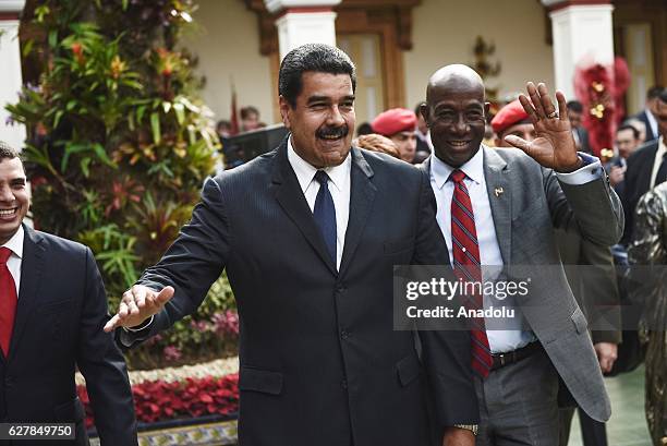 Venezuelan President Nicolas Maduro and Trinidad and Tobago Prime Minister Keith Rowley wave after a meeting at Miraflores presidential palace in...