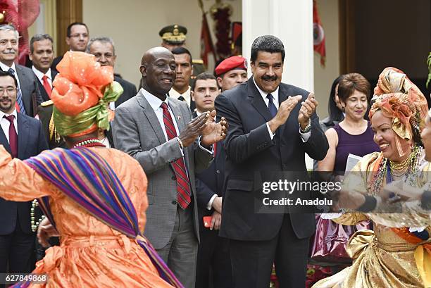 Enezuelan President Nicolas Maduro and Trinidad and Tobago Prime Minister Keith Rowley watch a folkloric dance crew at Miraflores presidential palace...