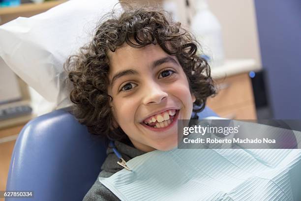 Hispanic child boy at the dentist office. Pristine smile waiting to become a perfect smile.