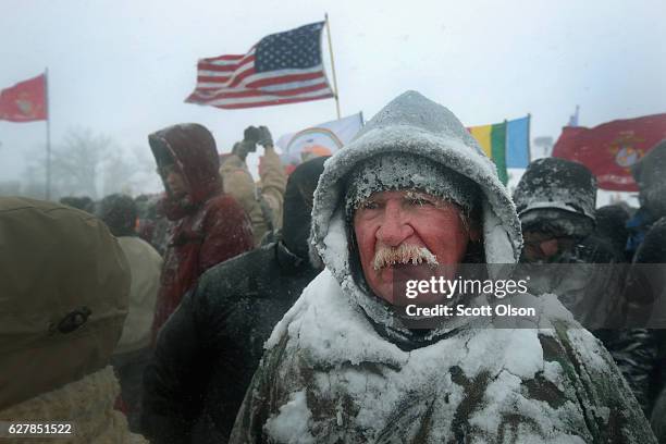 Despite blizzard conditions, military veterans march in support of the "water protectors" at Oceti Sakowin Camp on the edge of the Standing Rock...