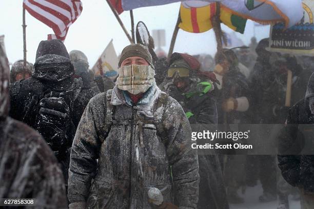 Despite blizzard conditions, military veterans march in support of the "water protectors" at Oceti Sakowin Camp on the edge of the Standing Rock...