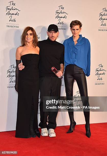 Demna Gvasalia and his award for International Ready To Wear Designer alongside Carine Roitfeld and Stella Tennant in the press room during The...