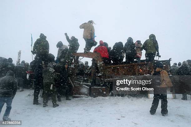 Despite blizzard conditions, military veterans march in support of the "water protectors" at Oceti Sakowin Camp on the edge of the Standing Rock...