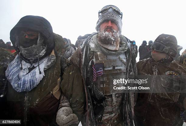 Despite blizzard conditions, military veterans march in support of the "water protectors" at Oceti Sakowin Camp on the edge of the Standing Rock...