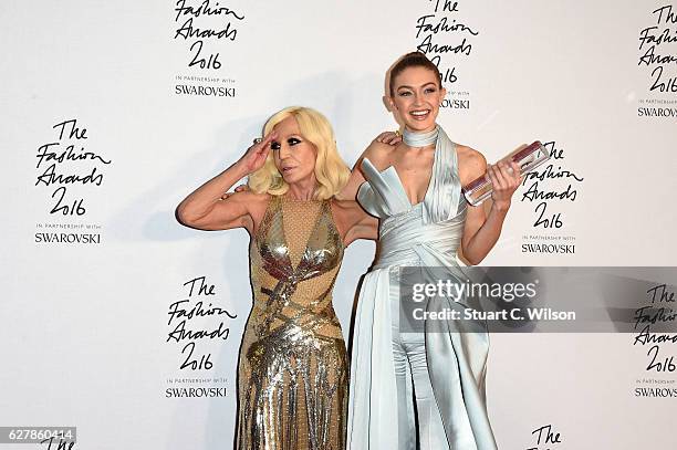 Model Gigi Hadid poses in the winners room with Donatella Versace after winning the International Model of the Year Award at The Fashion Awards 2016...