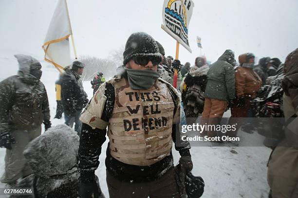 Despite blizzard conditions, military veterans march in support of the "water protectors" at Oceti Sakowin Camp on the edge of the Standing Rock...