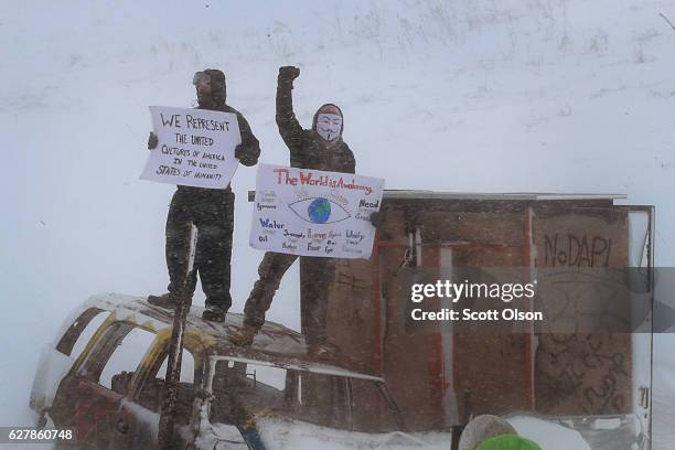 Despite blizzard conditions, activists show support as military veterans march in support of the "water protectors" at Oceti Sakowin Camp on the edge...