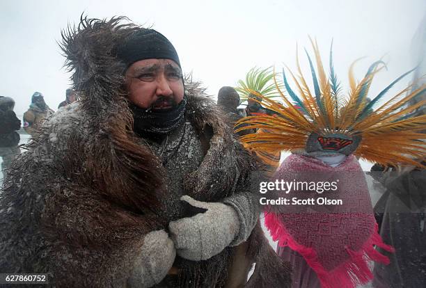 Despite blizzard conditions, military veterans march in support of the "water protectors" at Oceti Sakowin Camp on the edge of the Standing Rock...