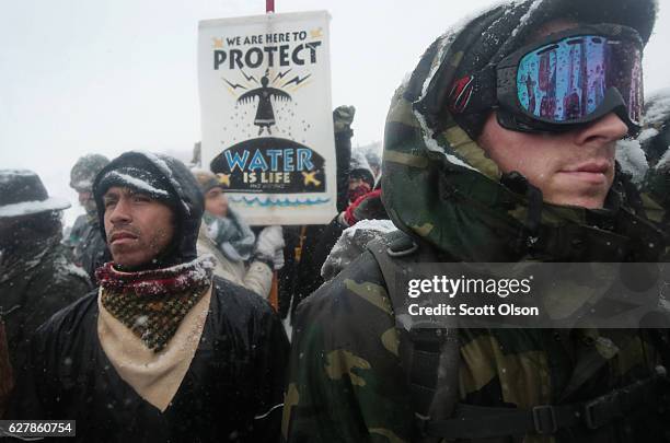 Despite blizzard conditions, military veterans march in support of the "water protectors" at Oceti Sakowin Camp on the edge of the Standing Rock...