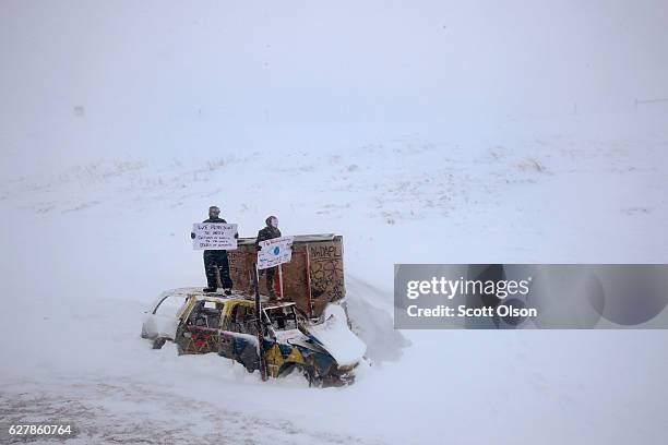 Despite blizzard conditions, activists show support as military veterans march in support of the "water protectors" at Oceti Sakowin Camp on the edge...