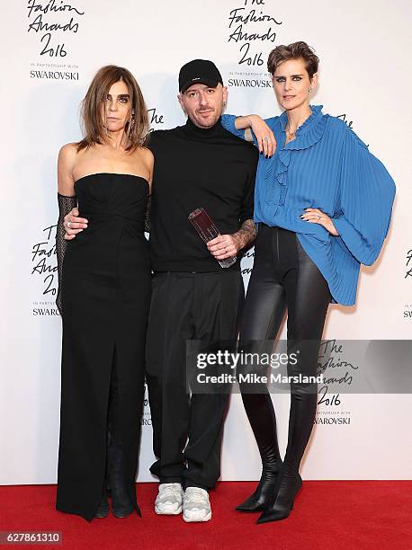 Designer Demna Gvasalia poses in the winners room with Carine Roitfeld and Stella Tennant after winning the International RTW Designer Award at The...