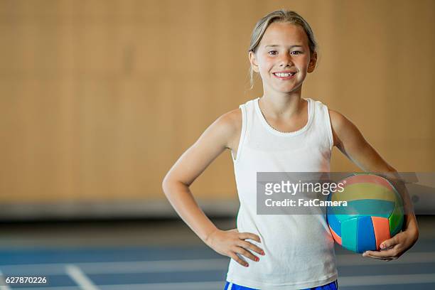 young girl playing volleyball - girls volleyball stock pictures, royalty-free photos & images