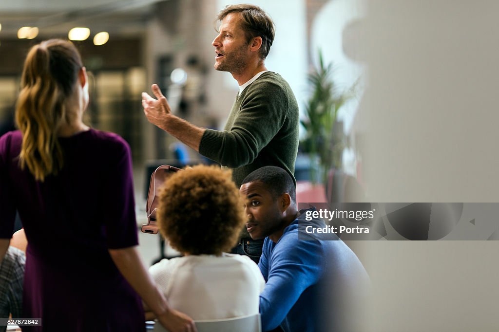 Businessman talking to colleagues in meeting