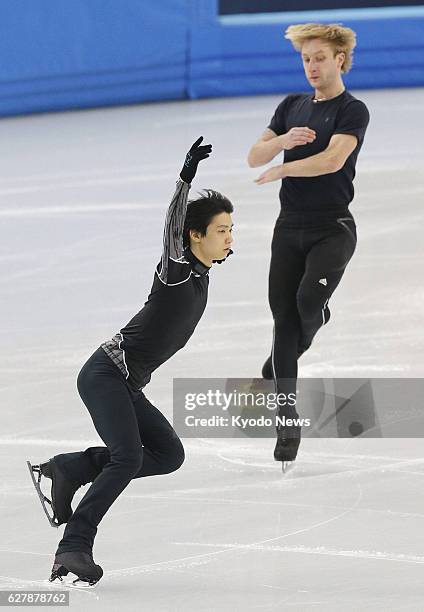 Russia - Japanese figure skater Yuzuru Hanyu and his Russian rival Evgeni Plushenko skate in an official practice session for the Sochi Olympic Games...