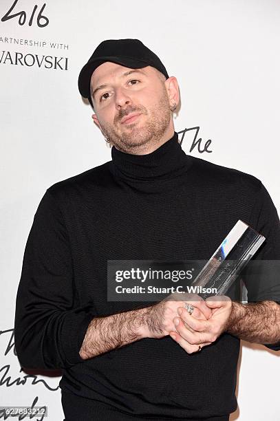 Designer Demna Gvasalia poses in the winners room after winning the International RTW Designer Award at The Fashion Awards 2016 at Royal Albert Hall...