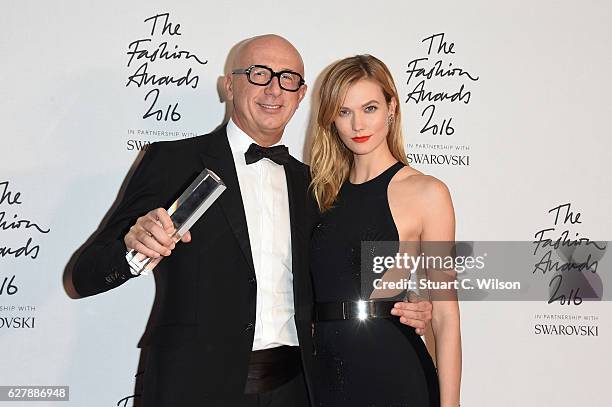 Gucci CEO Marco Bizzarri poses in the winners room with model Karlie Kloss after winning the International Business Leader Award at The Fashion...