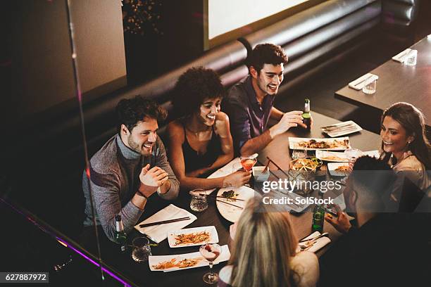 friends enjoying a meal - pub food stock pictures, royalty-free photos & images