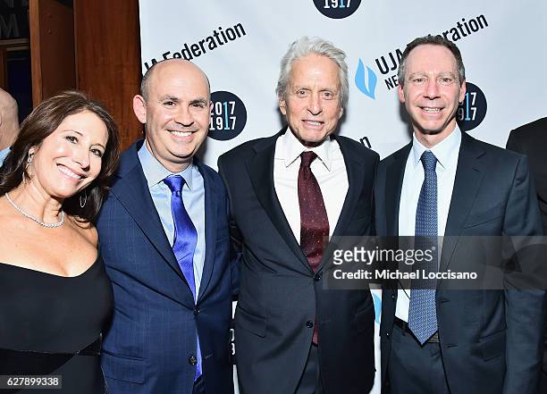 Linda Solomon, husband and honoree Jeffrey M. Solomon, actor Michael Douglas, and honoree Jeffrey Aronson attend the 2016 UJA-Federation of New York...