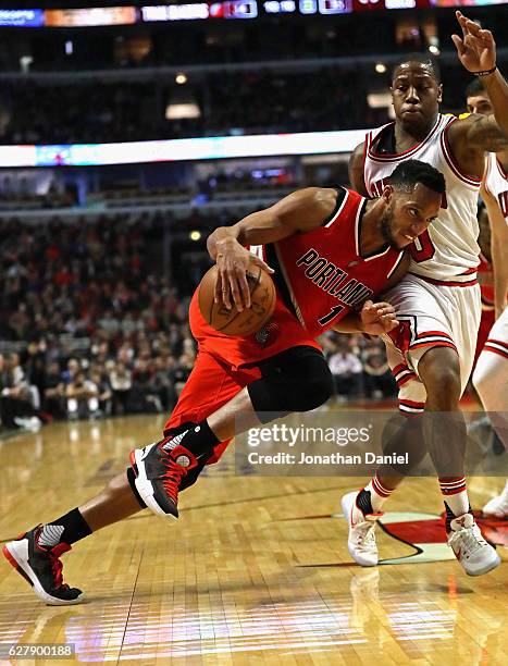 Evan Turner of the Portland Trail Blazers drives against Isaiah Canaan of the Chicago Bulls at the United Center on December 5, 2016 in Chicago,...