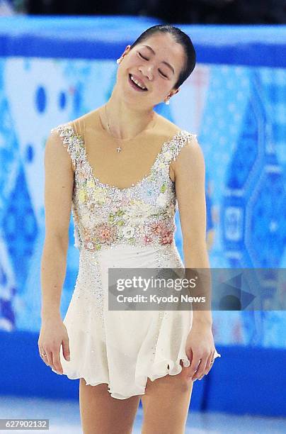 Russia - Team captain Akiko Suzuki of Japan reacts after competing in the women's free skating segment of the Winter Olympics figure skating team...