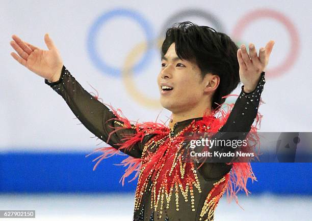 Russia - Tatsuki Machida of Japan, winner of the Cup of Russia and Skate America, responds to cheers after finishing his performance in the men's...