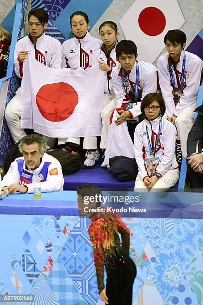 Russia - Japanese athletes cheer on compatriot Tatsuki Machida during the men's free skating segment of the Winter Olympics figure skating team event...