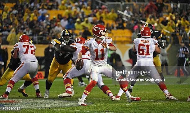 Quarterback Alex Smith of the Kansas City Chiefs passes as offensive linemen Eric Fisher, Zach Fulton and Mitch Morse block against the Pittsburgh...