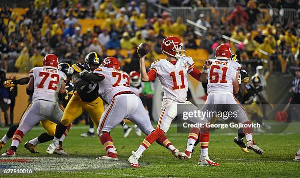Quarterback Alex Smith of the Kansas City Chiefs passes as offensive linemen Eric Fisher, Zach Fulton and Mitch Morse block against the Pittsburgh...