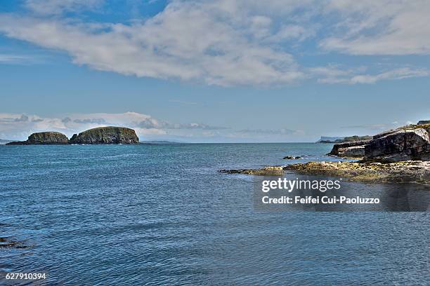 rocky coastline of ballintoy at county antrim in northern ireland - butte rocky outcrop stock pictures, royalty-free photos & images