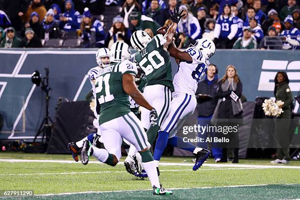 Dwayne Allen of the Indianapolis Colts completes a reception for a touchdown as Darron Lee of the New York Jets defends in the second quarter during...