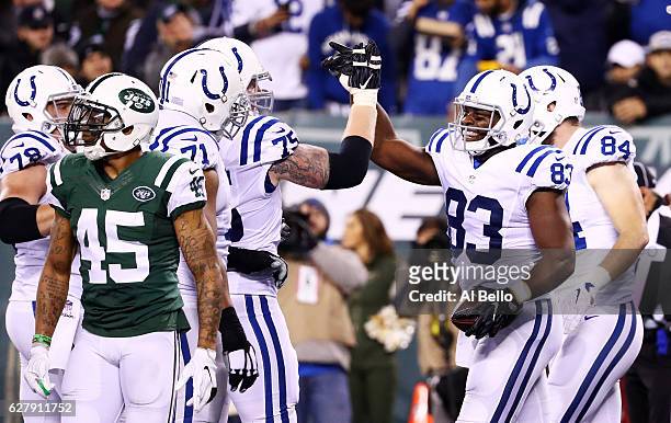 Dwayne Allen of the Indianapolis Colts celebrates his touchdown with teammates in the second quarter against the New York Jets during their game at...