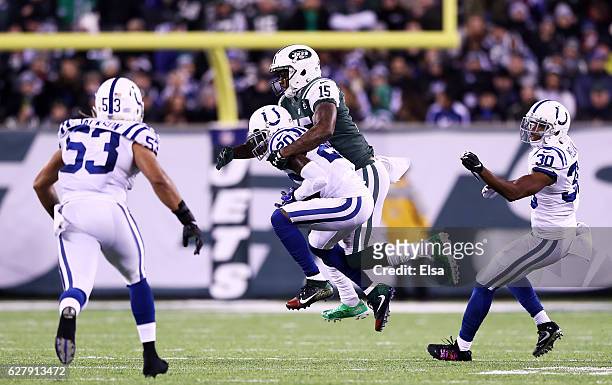 Darius Butler of the Indianapolis Colts intercepts a pass intended for Brandon Marshall of the New York Jets in the second quarter during their game...