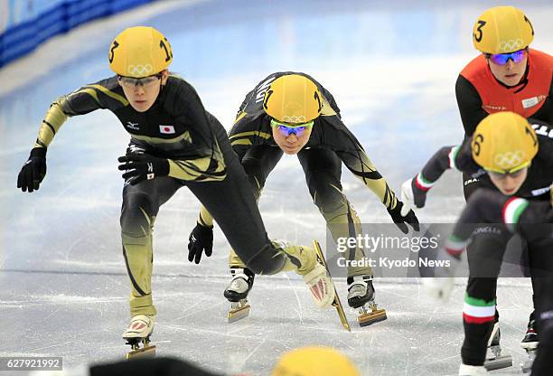 Russia - Japan's Yui Sakai pushes her teammate Sayuri Shimizu during the Winter Olympics women's 3,000-meter short track relay semifinals in Sochi,...