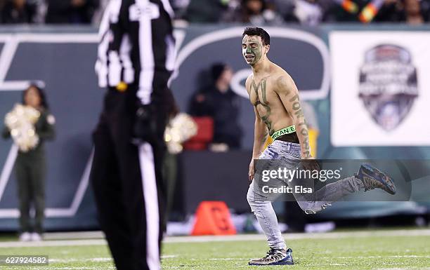 Fan runs on the field during the game between the New York Jets and the Indianapolis Colts at MetLife Stadium on December 5, 2016 in East Rutherford,...