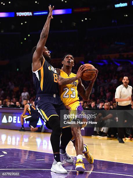 Louis Williams of the Los Angeles Lakers drives to the baskey on Shelvin Mack of the Utah Jazz during the first half at Staples Center on December 5,...