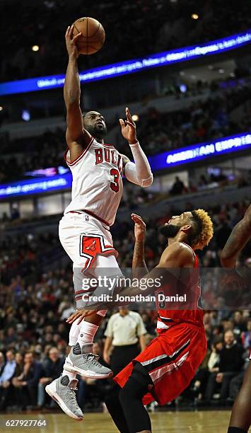 Dwyane Wade of the Chicago Bulls puts up a shot over Allen Crabbe of the Portland Trail Blazers on his way to a game-high 34 points at the United...