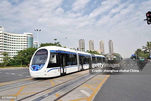 trams in zhuhai - ansaldobreda stock pictures, royalty-free photos & images