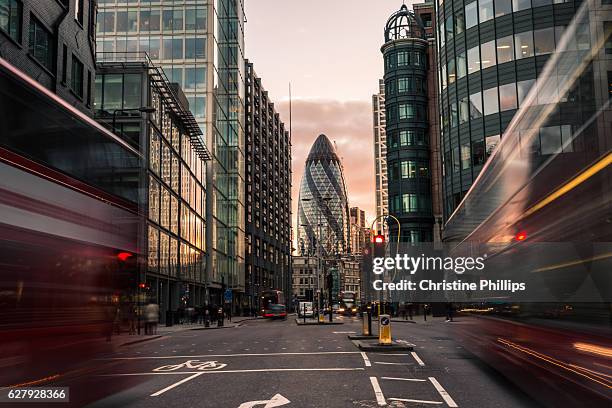 london busses rush to and from st mary axe in the financial district of the city of london - london brexit stock pictures, royalty-free photos & images