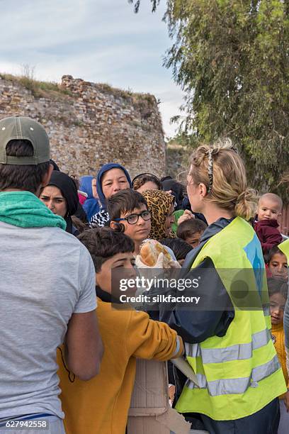 breakfast line in souda refugee camp on chios - quiosque stock pictures, royalty-free photos & images